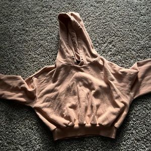 Cropped peach colored hoodie.